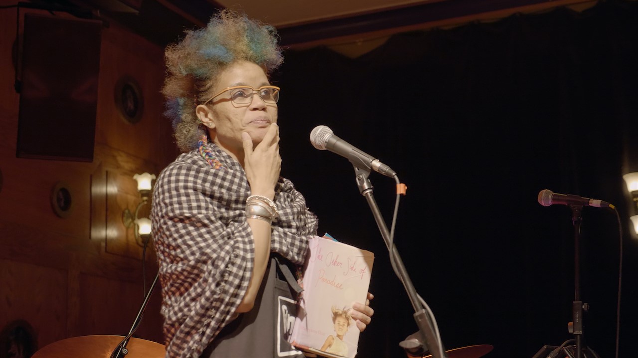 Woman stands at a microphone