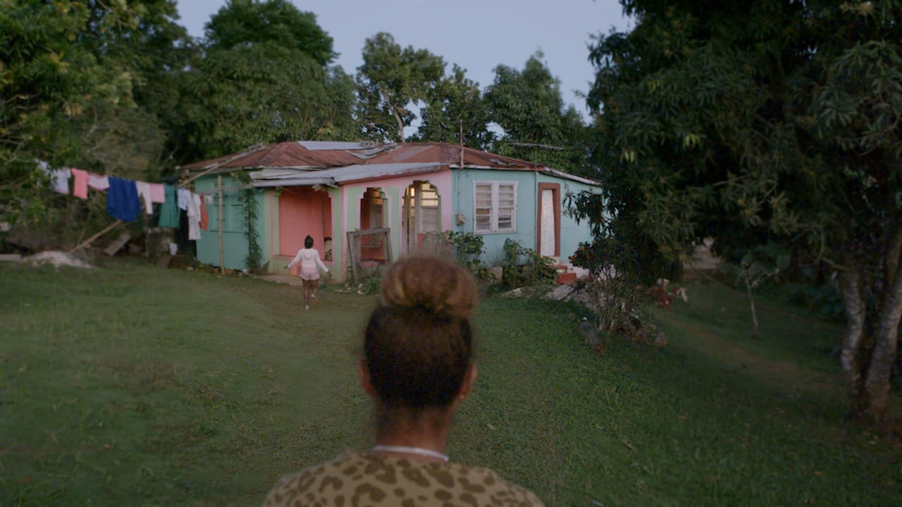 Woman looks at a bungalow