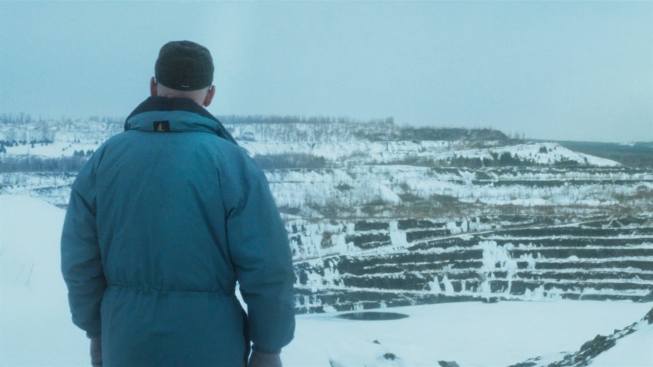 Man overlooking snow covered hills