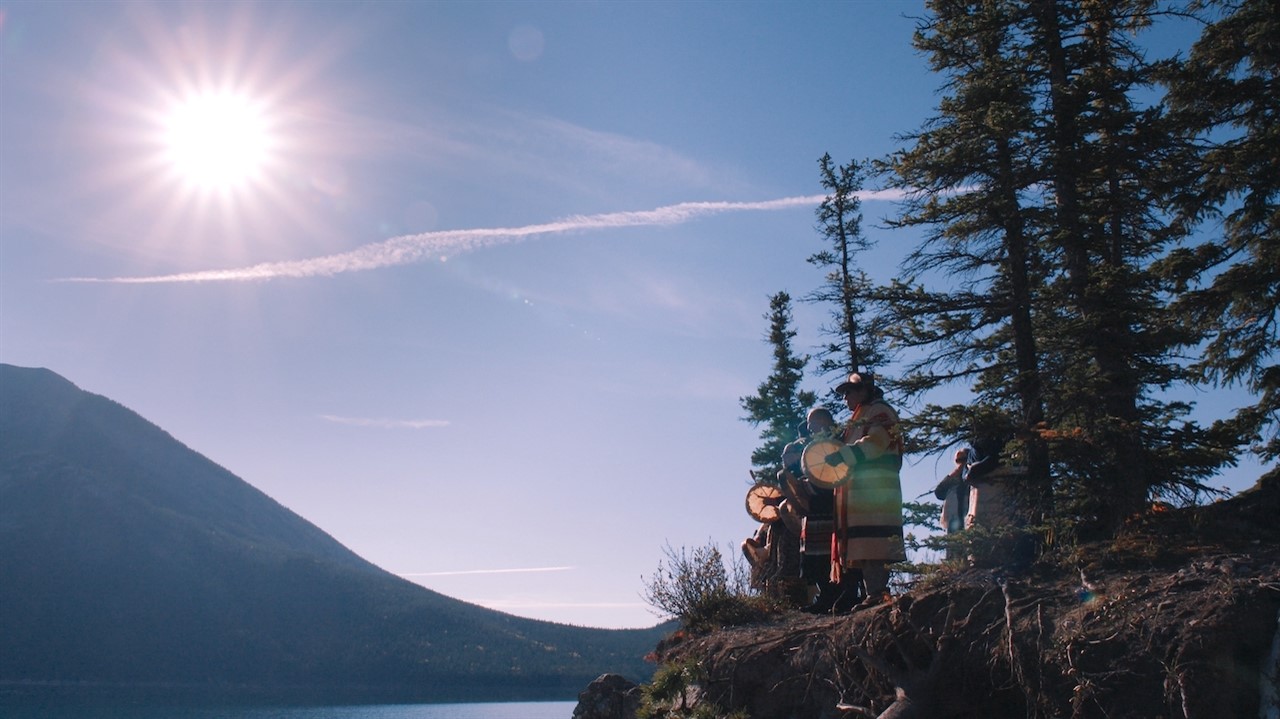 Indigenous drummers with a sunny, cloudless sky