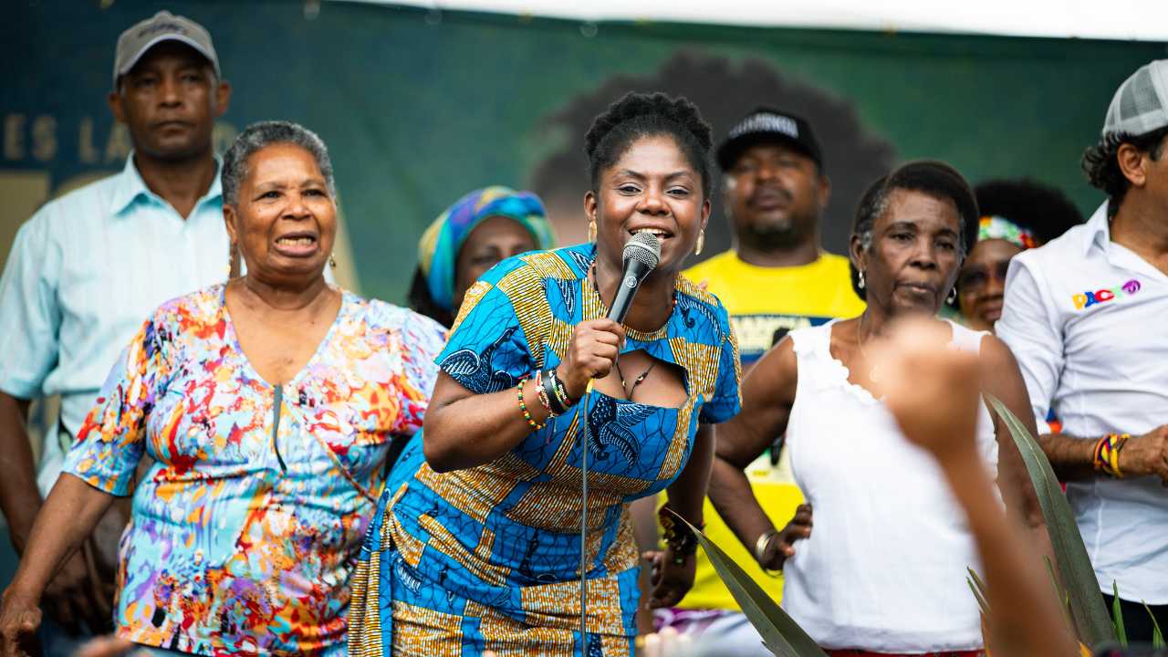 a woman speaking in front of a crowd