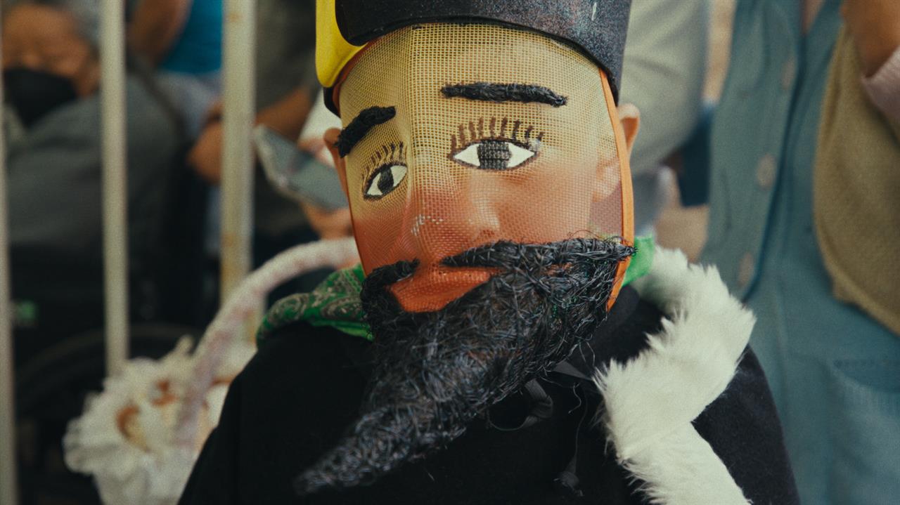 A boy dressed in a Chinelo dancer ’s costume