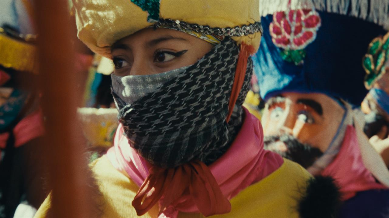 A female dancer in costume at a procession